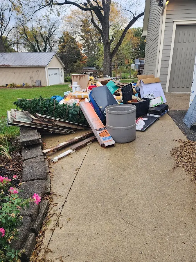 Dumpster being loaded with debris for Estate Cleanout Dumpster Rental in Edgartown